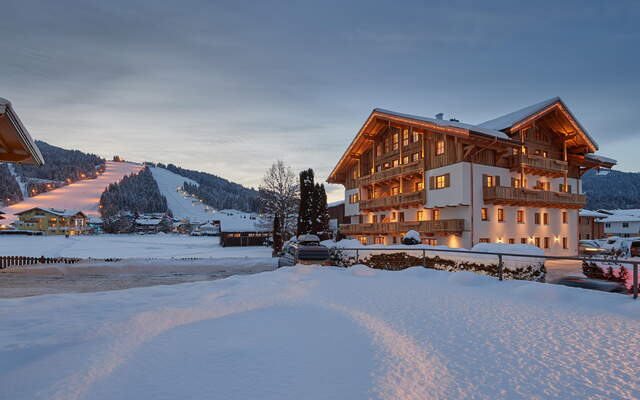 The Rainerhof in beautiful outdoor view in winter with a view of the piste