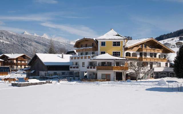 Under a blue winter sky, the Hubengut offers a beautiful home for its guests