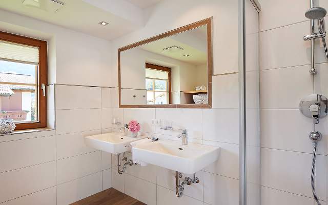Spacious bathroom with 2 sinks, shower and heated towel rail