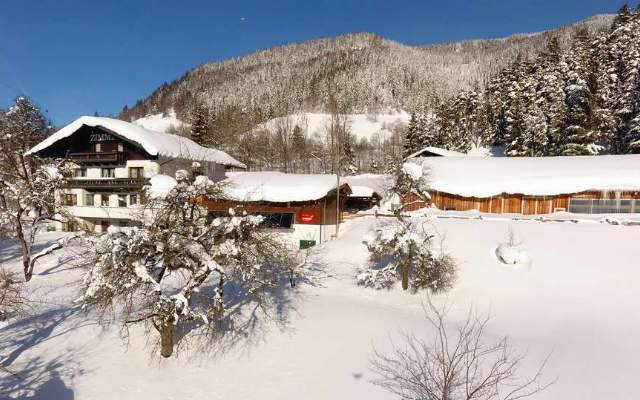 The Saumerhof in the snowy winter landscape