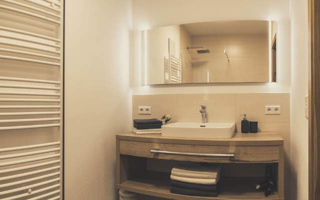 High quality bathroom with heated towel rail and glass shower